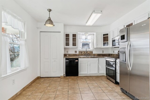 1648 S Cole St Unit B7, Lakewood, CO 80228 - kitchen with appliances with stainless steel finishes, white cabinets, and glass insert cabinets