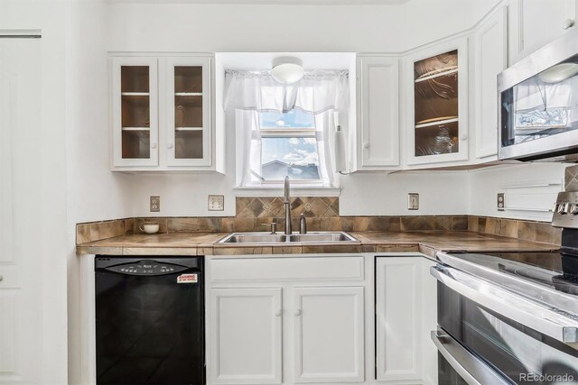 1648 S Cole St Unit B7, Lakewood, CO 80228 - kitchen featuring appliances with stainless steel finishes, white cabinets, and glass insert cabinets