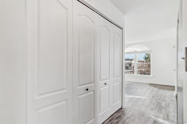 1648 S Cole St Unit B7, Lakewood, CO 80228 - hallway featuring wood finished floors and arched walkways