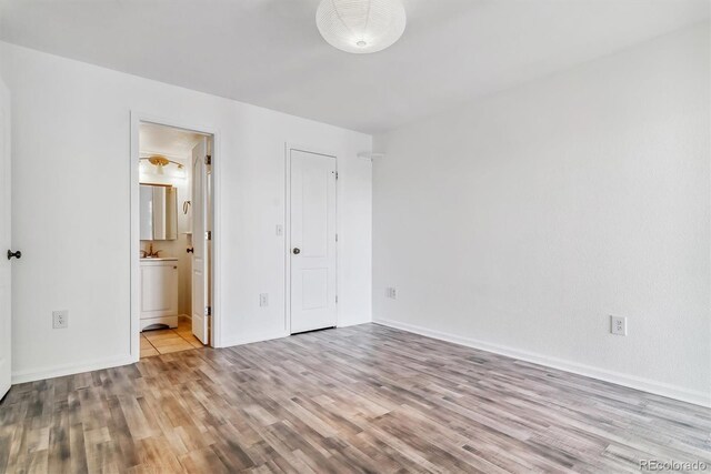 1648 S Cole St Unit B7, Lakewood, CO 80228 - unfurnished bedroom with wood finished floors and connected bathroom