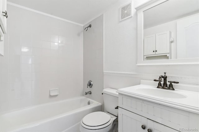 full bathroom featuring vanity, toilet, and tiled shower / bath