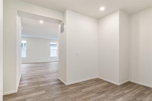 spare room featuring light hardwood / wood-style flooring