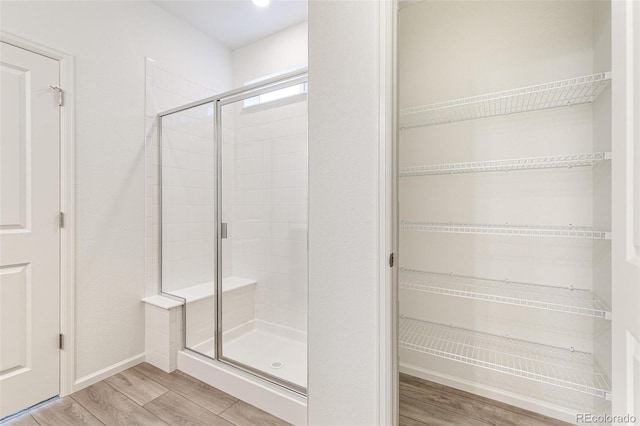 bathroom featuring hardwood / wood-style floors and walk in shower