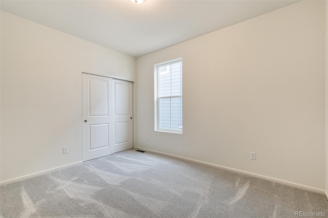 spare room featuring light carpet