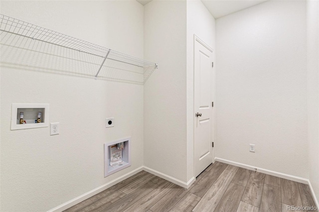 clothes washing area with hookup for an electric dryer, hardwood / wood-style floors, and washer hookup