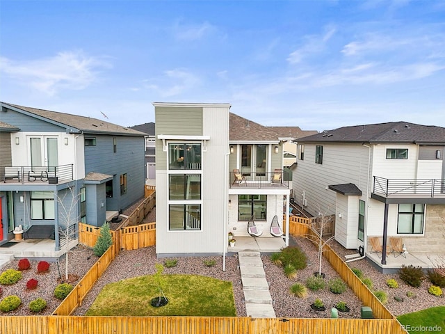 21440 E 61st Dr, Aurora, CO 80019 - back of property featuring a fenced backyard, a residential view, and a patio