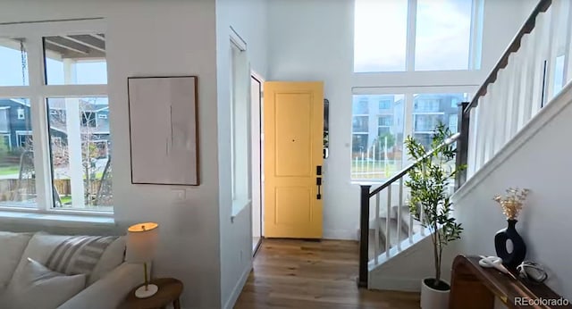 21440 E 61st Dr, Aurora, CO 80019 - doorway with plenty of natural light, wood finished floors, stairs, and a towering ceiling