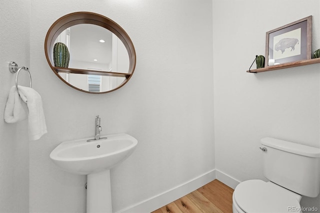 21440 E 61st Dr, Aurora, CO 80019 - half bath featuring wood finished floors, baseboards, and toilet