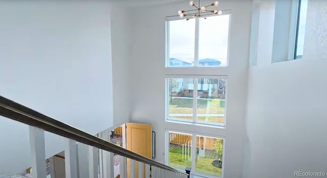 21440 E 61st Dr, Aurora, CO 80019 - stairs with a towering ceiling and a chandelier
