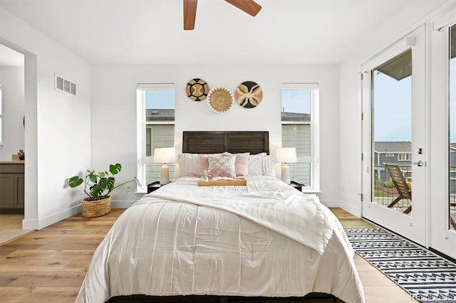 21440 E 61st Dr, Aurora, CO 80019 - bedroom featuring light wood-style flooring, access to outside, and multiple windows