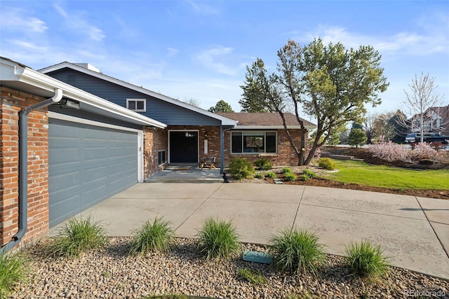 10801 W 29th Ave, Lakewood, CO 80215 - view of front facade featuring a garage, concrete driveway, and brick siding