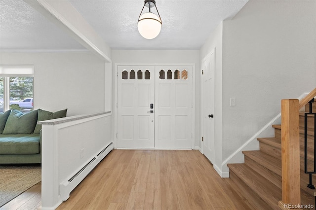 10801 W 29th Ave, Lakewood, CO 80215 - entryway with stairs, a textured ceiling, baseboard heating, and light wood-style flooring
