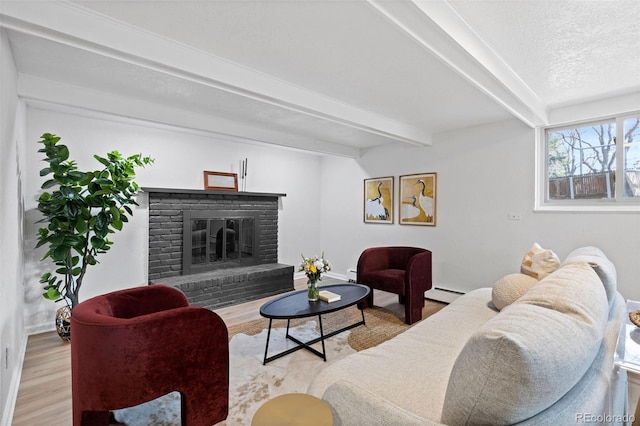 10801 W 29th Ave, Lakewood, CO 80215 - living room with a brick fireplace, baseboards, wood finished floors, a baseboard radiator, and beamed ceiling