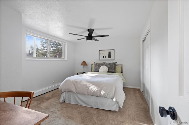 10801 W 29th Ave, Lakewood, CO 80215 - bedroom featuring carpet floors, a closet, baseboards, ceiling fan, and a baseboard heating unit