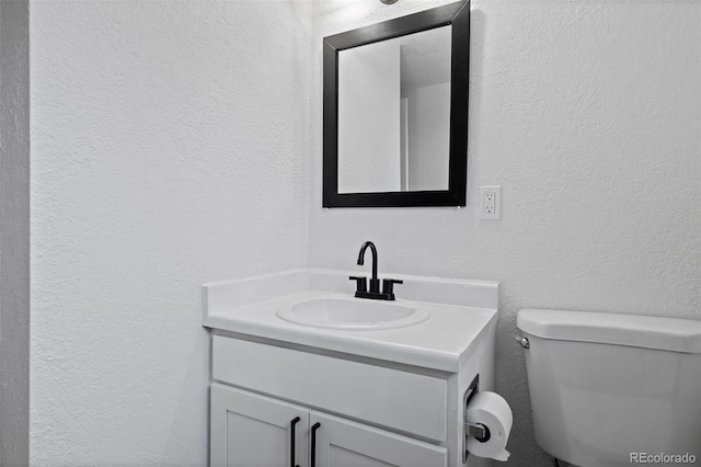 10801 W 29th Ave, Lakewood, CO 80215 - half bath with toilet, a textured wall, and vanity