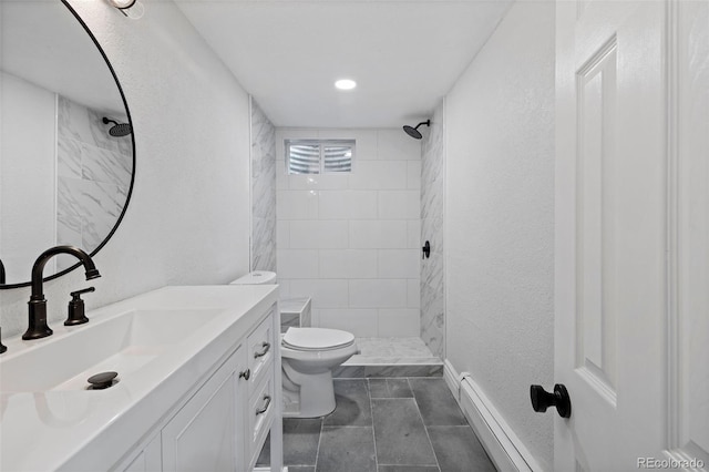 10801 W 29th Ave, Lakewood, CO 80215 - full bath featuring toilet, a baseboard heating unit, a tile shower, and vanity