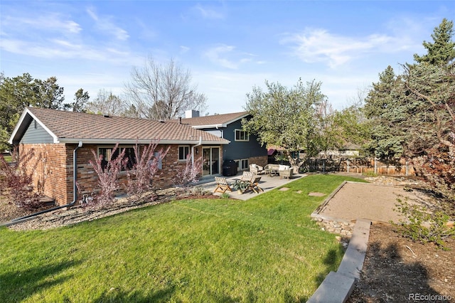 10801 W 29th Ave, Lakewood, CO 80215 - back of house featuring a chimney, a lawn, brick siding, fence, and a patio