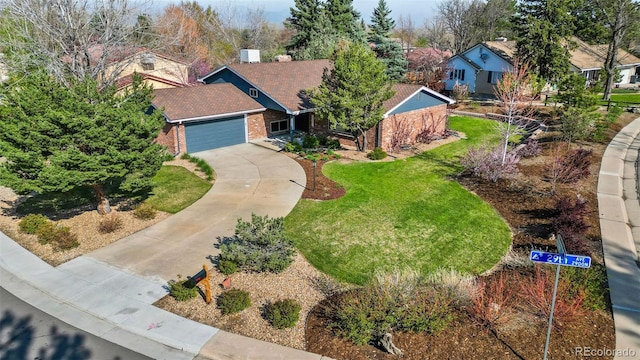 10801 W 29th Ave, Lakewood, CO 80215 - view of front of house featuring a residential view, brick siding, a garage, a front yard, and concrete driveway