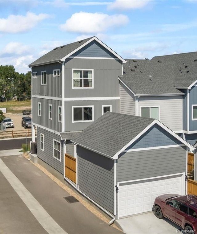 1530 Terry St, Longmont, CO 80501 - view of front of house with a shingled roof, concrete driveway, and an attached garage