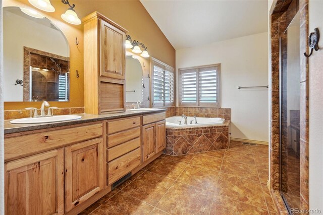 1625 N Yoder Rd, Yoder, CO 80864 - full bath with vaulted ceiling, a garden tub, a shower stall, double vanity, and tile patterned flooring