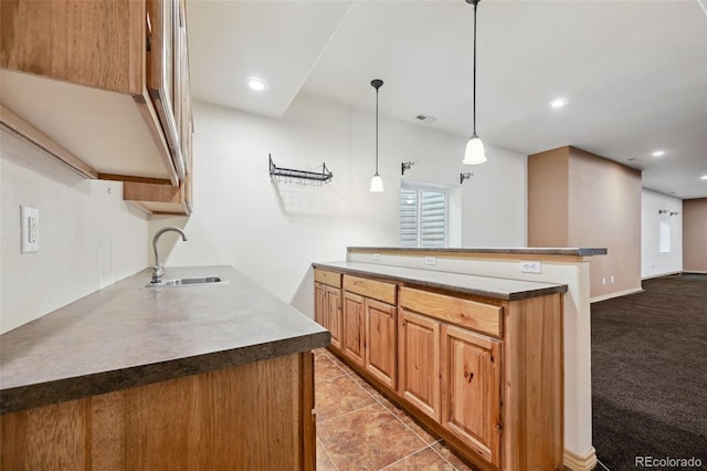 1625 N Yoder Rd, Yoder, CO 80864 - kitchen with a sink, hanging light fixtures, recessed lighting, light tile patterned floors, and brown cabinets