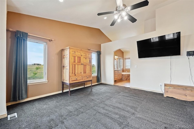 1625 N Yoder Rd, Yoder, CO 80864 - unfurnished living room with arched walkways, carpet, ceiling fan, lofted ceiling, and baseboards