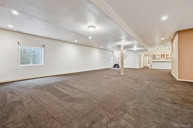 1625 N Yoder Rd, Yoder, CO 80864 - basement featuring carpet floors, recessed lighting, baseboards, and stairway