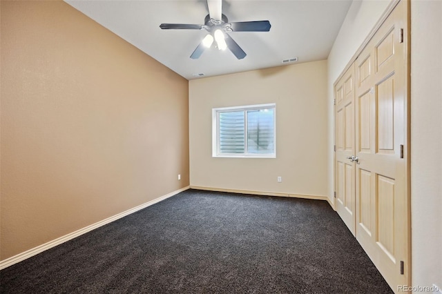1625 N Yoder Rd, Yoder, CO 80864 - unfurnished bedroom with dark colored carpet, baseboards, and ceiling fan