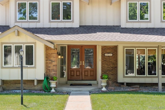 4810 W 102nd Pl, Westminster, CO 80031 - doorway to property featuring board and batten siding, a shingled roof, brick siding, and a yard