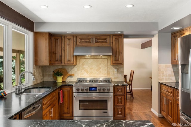 4810 W 102nd Pl, Westminster, CO 80031 - kitchen featuring appliances with stainless steel finishes, under cabinet range hood, wood finished floors, recessed lighting, and brown cabinets