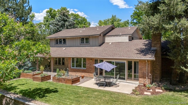 4810 W 102nd Pl, Westminster, CO 80031 - rear view of property featuring a garden, a patio area, roof with shingles, a yard, and a chimney