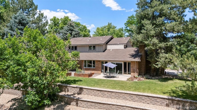 4810 W 102nd Pl, Westminster, CO 80031 - rear view of house featuring a patio area, a lawn, roof with shingles, and brick siding