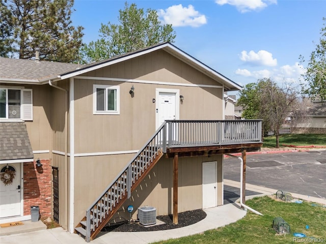 2271 Coronado Pkwy N Unit D, Denver, CO 80229 - view of front of home with roof with shingles, central AC unit, a deck, and stairs