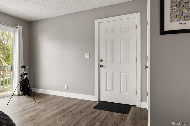 2271 Coronado Pkwy N Unit D, Denver, CO 80229 - entryway featuring wood finished floors, baseboards, and a textured ceiling