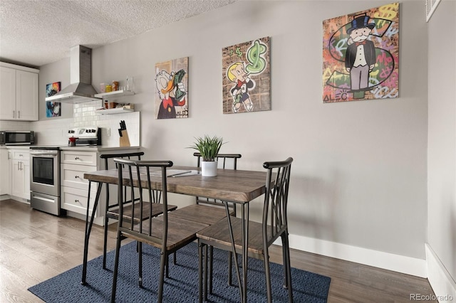 2271 Coronado Pkwy N Unit D, Denver, CO 80229 - dining room featuring dark wood-style flooring, baseboards, and a textured ceiling