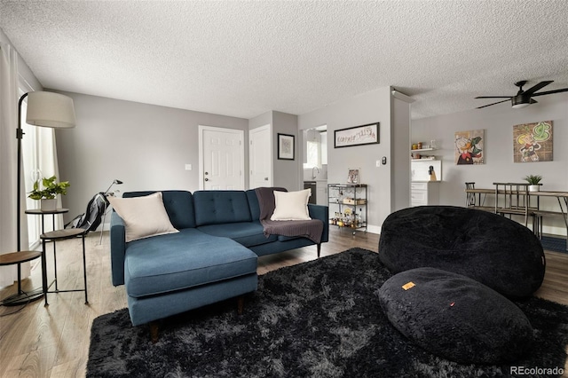 2271 Coronado Pkwy N Unit D, Denver, CO 80229 - living area featuring wood finished floors, a textured ceiling, and a ceiling fan