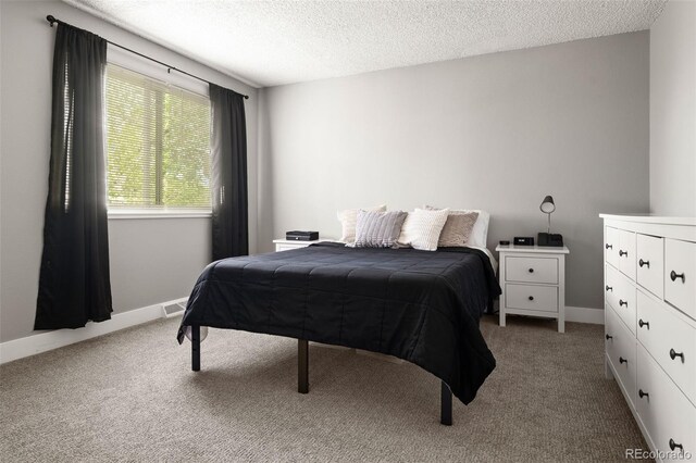 2271 Coronado Pkwy N Unit D, Denver, CO 80229 - carpeted bedroom featuring a textured ceiling and baseboards