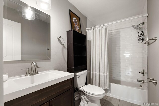 2271 Coronado Pkwy N Unit D, Denver, CO 80229 - full bathroom featuring toilet, vanity, and shower / tub combo with curtain