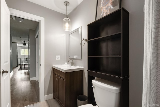 2271 Coronado Pkwy N Unit D, Denver, CO 80229 - full bath featuring toilet, vanity, wood finished floors, and baseboards