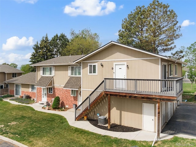 2271 Coronado Pkwy N Unit D, Denver, CO 80229 - view of front of home with a front lawn, a garage, roof with shingles, and central air condition unit