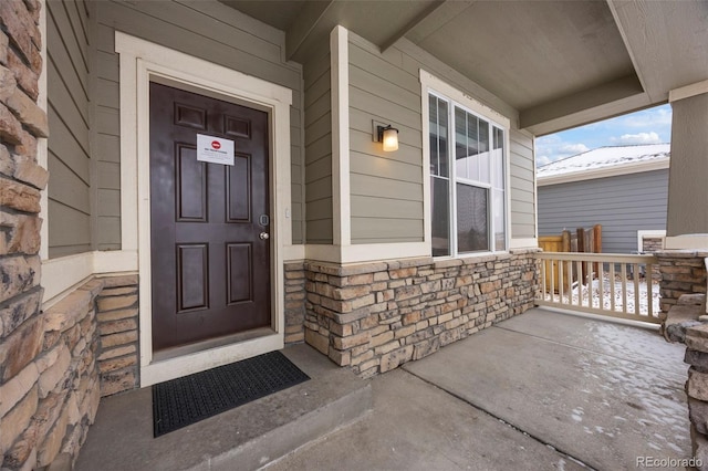 1523 Honeysuckle Ct, Brighton, CO 80601 - doorway to property featuring a porch and stone siding