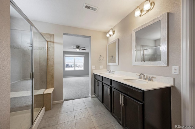 1523 Honeysuckle Ct, Brighton, CO 80601 - full bath featuring double vanity, ceiling fan, a shower stall, and tile patterned floors