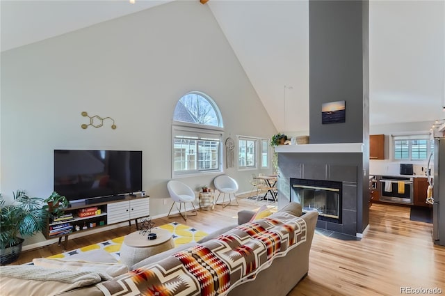 4861 Curie Ct, Boulder, CO 80301 - living area with high vaulted ceiling, plenty of natural light, light wood-style floors, and a fireplace