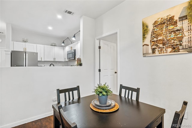 dining space featuring dark hardwood / wood-style floors