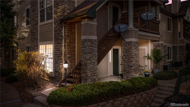 entrance to property with a balcony and cooling unit