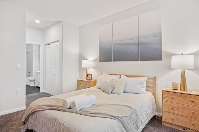 bedroom featuring ensuite bath and dark colored carpet