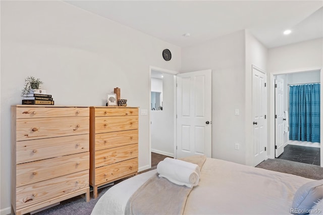 bedroom with dark colored carpet and a closet