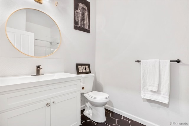 bathroom with toilet, vanity, tile patterned flooring, decorative backsplash, and an enclosed shower