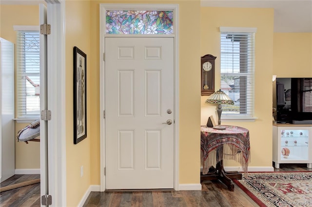 foyer featuring dark wood finished floors and baseboards