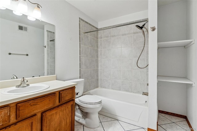 full bathroom with toilet, tiled shower / bath, vanity, and tile patterned floors